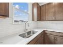 Bright kitchen with stainless steel sink, white countertops, and shaker cabinets at 270 Chestnut Oak Ln, Lillington, NC 27546