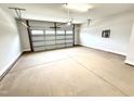 Spacious two-car garage with a concrete floor and a white garage door at 316 Bishop Ln, Sanford, NC 27330
