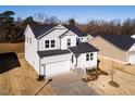 Two-story house, gray siding, white trim, two-car garage, and a small front yard at 395 Fast Pitch Ln, Four Oaks, NC 27524