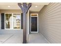 Covered front porch with gray columns, a black front door, and a large window at 52 Gander Dr, Benson, NC 27504
