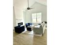 Bright living room featuring modern furniture, a fireplace, and a ceiling fan at 242 Sequoia Dr, Louisburg, NC 27549