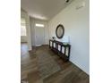 Bright foyer features a long console table, decorative mirror, and a patterned rug runner at 466 Saint Clair Dr, Fuquay Varina, NC 27526