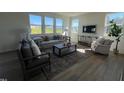 Cozy living room with comfortable seating, large windows, and a decorative area rug at 466 Saint Clair Dr, Fuquay Varina, NC 27526