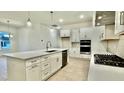 The kitchen has stainless steel appliances, a kitchen island, and wooden floors at 2048 Abbeyhill Dr # 98, Raleigh, NC 27610
