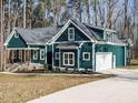 House exterior showcasing a two-car garage and large backyard at 30 Tamaran Ct, Spring Hope, NC 27882