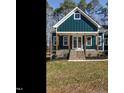 Front view of charming house with brick accents and a welcoming porch at 30 Tamaran Ct, Spring Hope, NC 27882