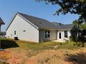 Well-maintained home exterior with neutral siding, a dark roof, and a cozy patio area at 3102 Castlerock Dr # 2, Burlington, NC 27215