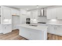 New kitchen with white cabinets, stainless appliances and a center island at 736 Heathered Farm Way, Apex, NC 27523