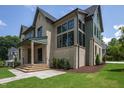 Exterior showcasing brick and siding, black-trimmed windows, and a meticulously landscaped lawn at 1000 Marilyn Dr, Raleigh, NC 27607
