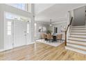 Two-story foyer with hardwood floors, staircase, and formal dining area at 11603 Broadfield Ct, Raleigh, NC 27617