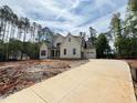 Beautiful home with a long concrete driveway leading to an attached garage, surrounded by lush trees at 155 Gaines Trl, Pittsboro, NC 27312