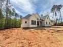 Side view of a craftsman-style home on a spacious lot, surrounded by tall trees and natural beauty at 155 Gaines Trl, Pittsboro, NC 27312