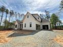 A modern craftsman-style home featuring an attached garage and a spacious driveway at 155 Gaines Trl, Pittsboro, NC 27312