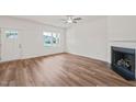 Bright living room with hardwood floors, a ceiling fan, fireplace and an abundance of natural light at 148 Harmony Trl, Broadway, NC 27505