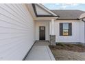 Inviting front entrance with a dark door, stone accents, and a walkway at 177 Ruskin Dr, Smithfield, NC 27577