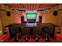 Unique theater room with tiered seating, custom lighting, and a large screen for an immersive cinematic experience at 1820 Oatlands Court Ct, Wake Forest, NC 27587