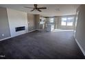 Open living room with LVP flooring, fireplace, and kitchen island at 212 Tuscany Cir, Princeton, NC 27569