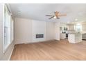 Bright living room with wood flooring, fireplace, and open concept layout to the kitchen at 300 Tuscany Cir, Princeton, NC 27569