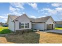 Charming home featuring light siding, stone accents, and well-manicured landscaping at 102 Burnello Ct, Princeton, NC 27569