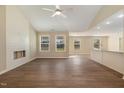 Spacious living room with hardwood floors, a decorative fireplace, and plenty of natural light at 102 Burnello Ct, Princeton, NC 27569