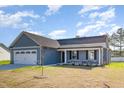 Inviting single-story home featuring stone accents, a covered front porch, and an attached two-car garage at 104 Burnello Ct, Princeton, NC 27569