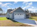 Attached garage with a wide driveway, offering convenience and ample parking space for residents and guests at 104 Burnello Ct, Princeton, NC 27569