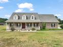 Charming brick home with a large, inviting front porch and well-manicured lawn at 2674 Stanton Hill Rd, Cameron, NC 28326