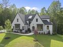 Beautiful two-story home with professionally landscaped yard, colorful flowerbeds, and mature trees at 7621 Falls Creek Ln, Raleigh, NC 27614