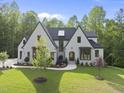 Striking two-story home featuring a manicured lawn, neat flowerbeds, and a timeless design at 7621 Falls Creek Ln, Raleigh, NC 27614
