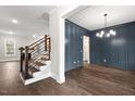 Elegant dining room boasts dark blue wainscoting and hardwood floors at 406 Terry Rd, Hillsborough, NC 27278