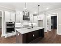 Modern kitchen features a large island, stainless steel appliances, and white shaker cabinets at 406 Terry Rd, Hillsborough, NC 27278