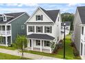 Stylish two-story home with a welcoming covered front porch and landscaped front yard is ideal for families at 9249 Kitchin Farms Way # 432, Wake Forest, NC 27587