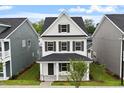 Beautiful two-story home boasts a classic design, neat landscaping, and a cozy covered front porch at 9249 Kitchin Farms Way # 432, Wake Forest, NC 27587