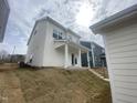 The back of this home features a covered patio and grassy backyard at 9249 Kitchin Farms Way # 432, Wake Forest, NC 27587
