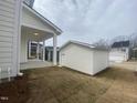 The rear of the house features a covered porch, small yard and a detached garage at 9249 Kitchin Farms Way # 432, Wake Forest, NC 27587