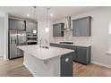 Kitchen with stainless steel appliances, light countertops, and gray cabinets at 9249 Kitchin Farms Way # 432, Wake Forest, NC 27587