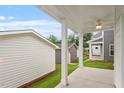 Covered patio featuring ceiling fan, view of the backyard, and white support columns at 9249 Kitchin Farms Way # 432, Wake Forest, NC 27587