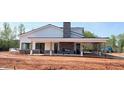 Exterior view of community pool house with covered porch, fireplace, and playground at 187 Pinkie Ln, Garner, NC 27529