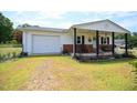 Lovely home with an attached garage and inviting front porch perfect for relaxing at 101 Mulberry Ln, Dunn, NC 28334