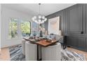Stylish dining room with modern chandelier, gray accent wall, and sleek furnishings at 861 Wimbleton Dr, Raleigh, NC 27609