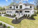 Daytime shot of the two-story home featuring stone accents and manicured lawn at 861 Wimbleton Dr, Raleigh, NC 27609