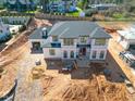 Aerial view of a new two-story construction home featuring brick work and visible framing at 865 Wimbleton Dr, Raleigh, NC 27609