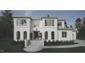 Elegant two-story white home featuring a symmetrical facade with large windows and manicured landscaping at 865 Wimbleton Dr, Raleigh, NC 27609