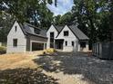 Newly constructed two-story home featuring a gray exterior, a black roof, and an attached two-car garage at 708 Catawba St, Raleigh, NC 27609