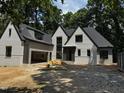 Newly constructed two-story home featuring a gray exterior, a black roof, and an attached two-car garage at 708 Catawba St, Raleigh, NC 27609