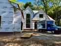 New home construction showing windows, building materials, and lumber delivery at 708 Catawba St, Raleigh, NC 27609