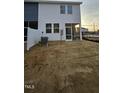 Backyard with screened porch and unfinished landscaping at 1328 Bessie Ct, Wake Forest, NC 27587