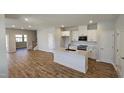 Modern kitchen with white cabinets, island, and stainless steel appliances at 1328 Bessie Ct, Wake Forest, NC 27587