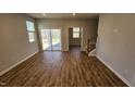 Spacious living room with hardwood floors and sliding glass doors at 1328 Bessie Ct, Wake Forest, NC 27587