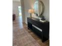 Inviting entryway features stylish console table, round mirror and wood flooring, setting a welcoming tone at 115 Shooting Star Trl, Youngsville, NC 27596